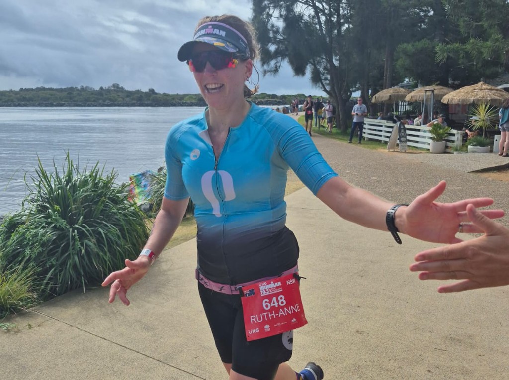 Athlete high-fiving during an IRONMAN 70.3 run