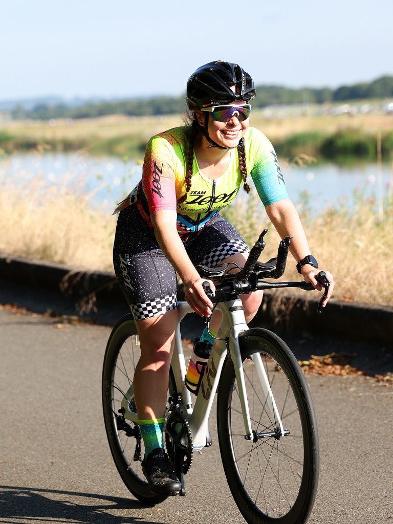 Athlete cycling outdoors in Team Zoot kit