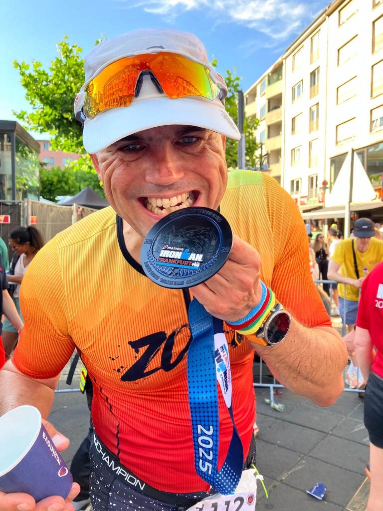 Athlete celebrating with an IRONMAN Frankfurt medal