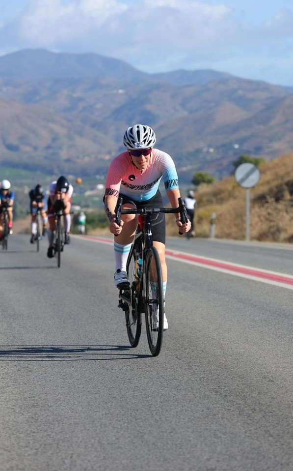 Cyclist racing toward the camera on a mountain road