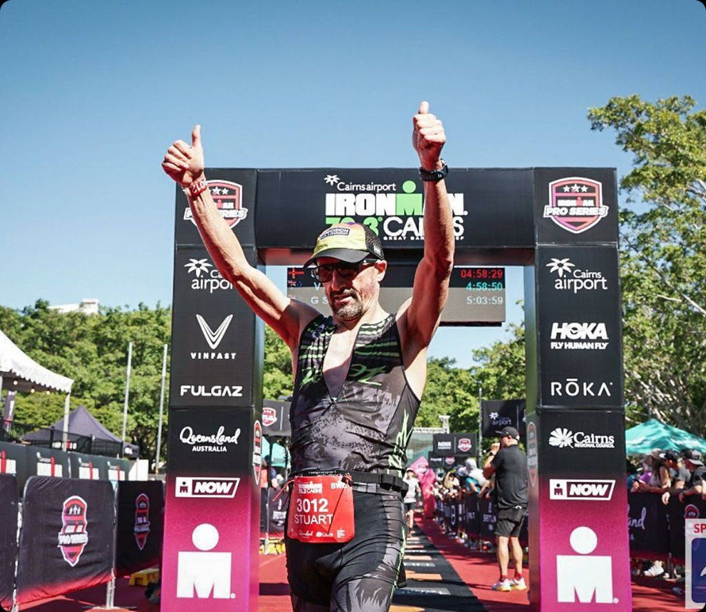Athlete celebrating at the IRONMAN 70.3 Cairns finish line
