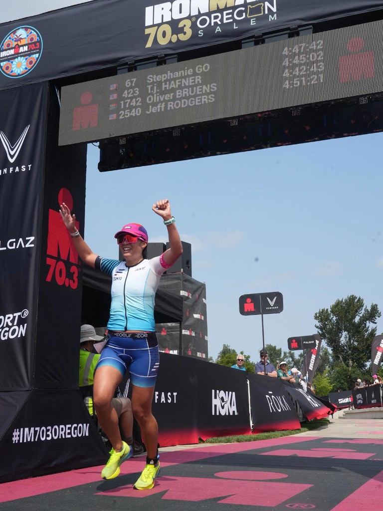 Athlete celebrating at the IRONMAN 70.3 Santa Cruz finish line