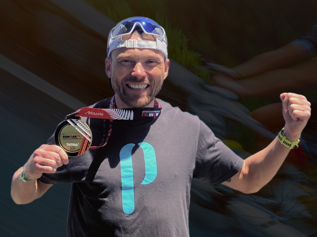 Athlete celebrating with an IRONMAN 70.3 World Championship Taupo medal